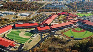 Aerial view of Ballparks of America complex. Two baseball fields and two rows of buildings are shown.